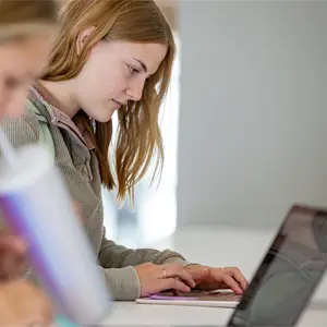 Female student look down at laptop