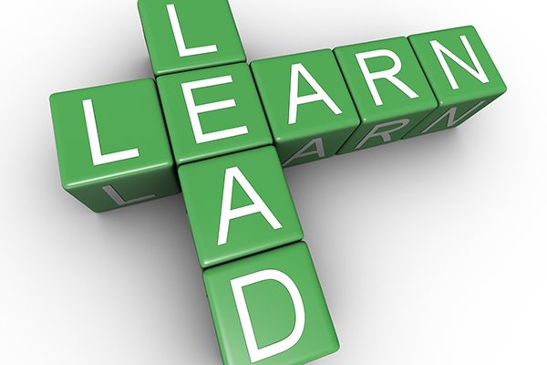 Image of text similar to scrabble board that says learn lead