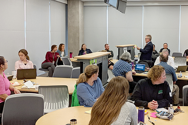 image of people actively working together on a project with post-it notes and pens