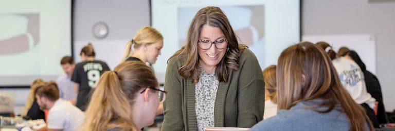 Department Chair, Professor Jeanie McHugo, PhD, PA-C, observes students' skills during their casting lab.