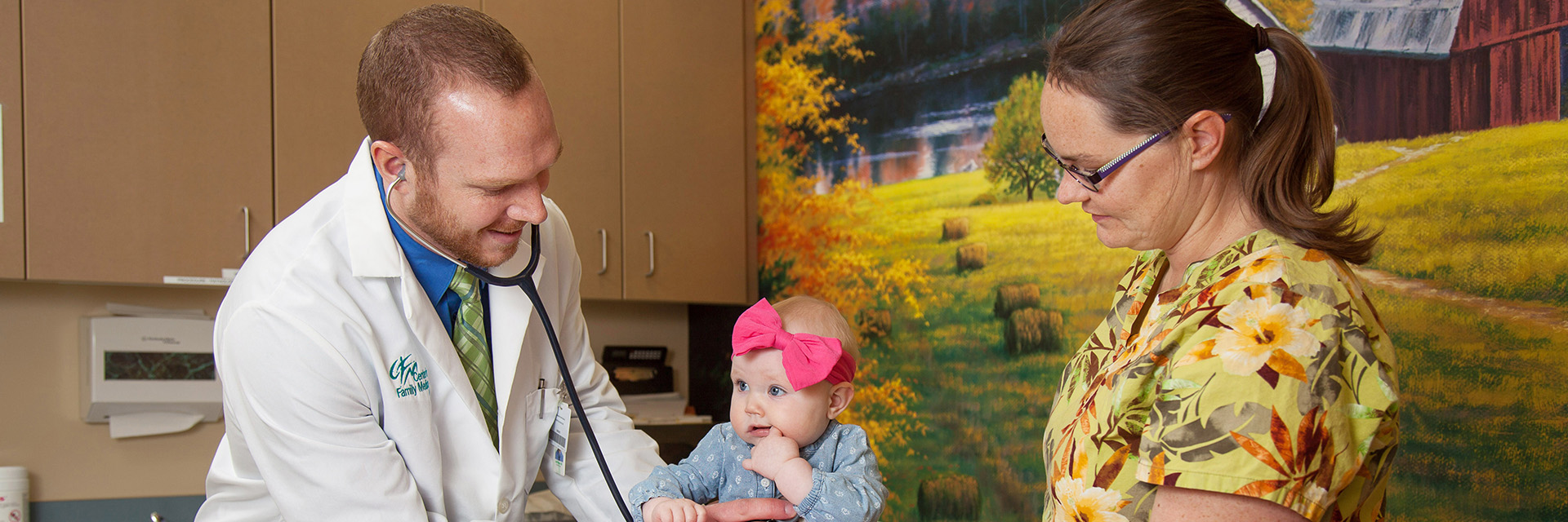 doctor with infant patient and mother
