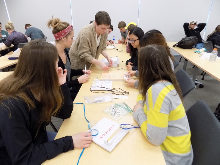 medical students tying knots at surgery interest group meeting
